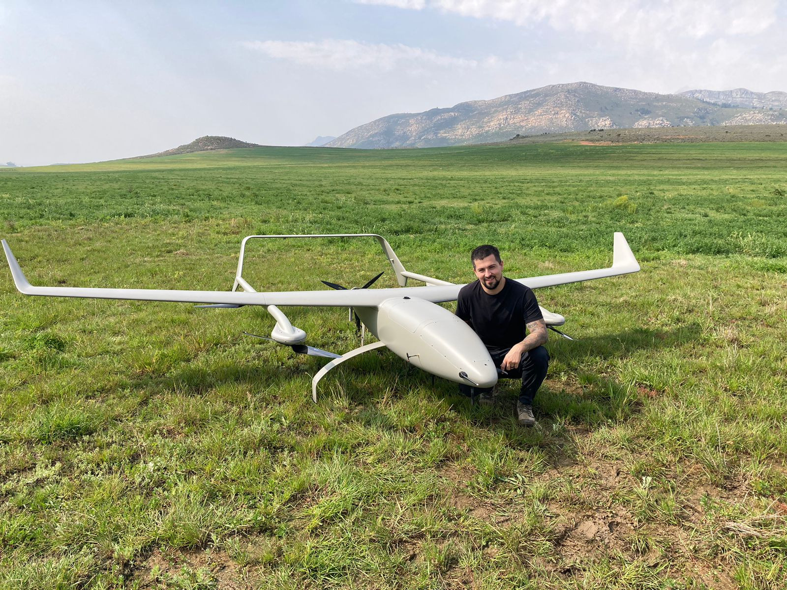 UAS operator watching fixed-wing drone in flight